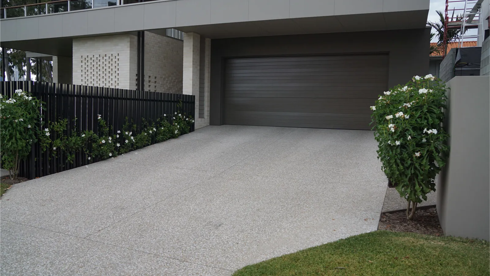 Long-lasting exposed aggregate concrete driveway outside a modern Adelaide home